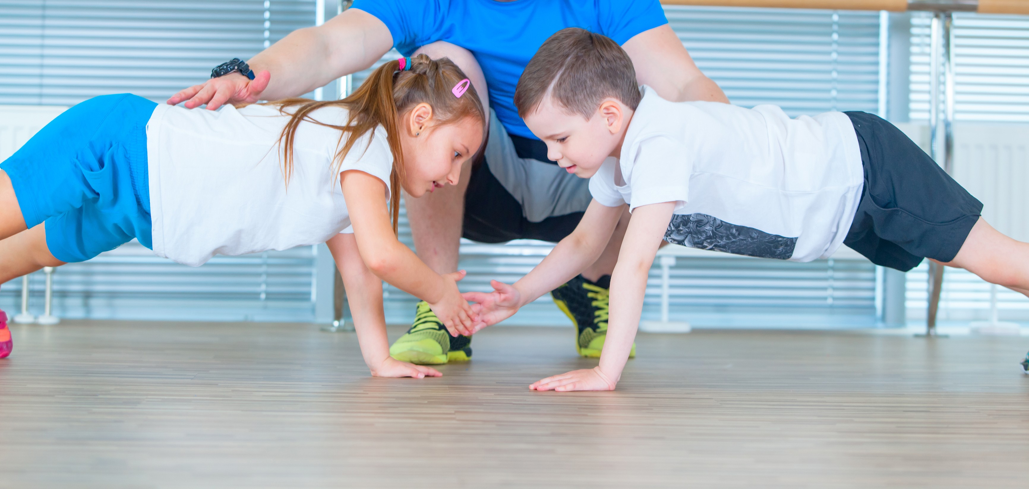 Children doing exercises with fitness instructor